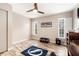 Well-lit bedroom with wood-look flooring, shuttered windows and neutral paint at 7200 Arbor View Ln, New Port Richey, FL 34653