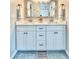 Bathroom featuring a double sink vanity with a decorative mirror and modern fixtures at 7425 245Th E St, Myakka City, FL 34251