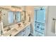Bathroom featuring a double sink vanity with a decorative mirror and modern fixtures at 7425 245Th E St, Myakka City, FL 34251