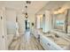 Luxurious Primary bathroom with double vanity, marble countertops, and soaking tub at 7425 245Th E St, Myakka City, FL 34251