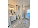 Bathroom featuring a single sink vanity with a decorative mirror and walkout access at 7425 245Th E St, Myakka City, FL 34251