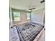 Spacious bedroom featuring wood-look floors, modern ceiling fan, and large windows at 7425 245Th E St, Myakka City, FL 34251