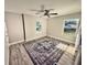 Bedroom showcasing two windows, ceiling fan, and wood-look flooring with a decorative rug at 7425 245Th E St, Myakka City, FL 34251