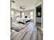 Bedroom featuring two windows, ceiling fan, and shiplap wall with an ensuite bathroom at 7425 245Th E St, Myakka City, FL 34251
