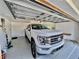 Spacious garage showcasing a white pickup truck and epoxy flooring with a clean, organized aesthetic at 7425 245Th E St, Myakka City, FL 34251