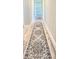 Hallway featuring wood-look flooring and a decorative patterned rug at 7425 245Th E St, Myakka City, FL 34251