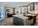 Open floor plan with an island kitchen overlooking the living room and a fireplace at 7425 245Th E St, Myakka City, FL 34251