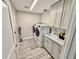 Well-lit laundry room with built-in cabinets, sink and countertop, and a modern washer and dryer set at 7425 245Th E St, Myakka City, FL 34251
