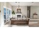 Comfortable living room with a fireplace, leather sofa, and access to the outdoors through sliding glass doors at 7425 245Th E St, Myakka City, FL 34251