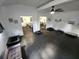 Spacious interior with black floor, white walls, ceiling fan and dog beds throughout at 7425 245Th E St, Myakka City, FL 34251