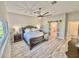 Primary bedroom with a king-sized bed, ceiling fan, and ensuite bathroom at 7425 245Th E St, Myakka City, FL 34251