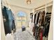 Expansive walk-in closet with custom shelving and natural light from a window at 7425 245Th E St, Myakka City, FL 34251