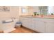 Bright bathroom featuring double vanity, granite counters, soaking tub, and tiled floor at 960 Starkey Rd # 3106, Largo, FL 33771