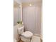 Bathroom featuring neutral walls, a shower with patterned curtain, and plush toilet cover at 960 Starkey Rd # 3106, Largo, FL 33771