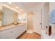 Well-lit bathroom with dual sinks, granite countertops, and a glass-enclosed shower at 960 Starkey Rd # 3106, Largo, FL 33771