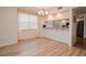 Open dining area with wood floors, large window, and adjacent kitchen view at 960 Starkey Rd # 3106, Largo, FL 33771
