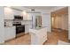 Bright kitchen featuring an island, stainless steel appliances, and granite countertops at 960 Starkey Rd # 3106, Largo, FL 33771