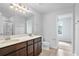 Modern bathroom featuring a double vanity, sleek fixtures, and a glass-enclosed shower at 10822 Windswept Garden Way, Tampa, FL 33647