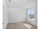 Bedroom with neutral carpet features a large window overlooking the exterior landscape at 10822 Windswept Garden Way, Tampa, FL 33647