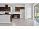Modern kitchen with dark wood cabinets, stainless steel appliances, and a spacious island at 10822 Windswept Garden Way, Tampa, FL 33647