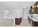 Kitchen with island features stainless steel appliances and dark brown cabinetry at 10822 Windswept Garden Way, Tampa, FL 33647