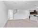 Bright, open-concept living area with plush carpeting seamlessly connected to the kitchen at 10822 Windswept Garden Way, Tampa, FL 33647