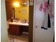 Bathroom features a dark wood vanity, large mirror, tile floor, and white door at 10933 Subtle Trail Dr, Riverview, FL 33569