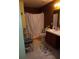 Bathroom with floral shower curtain, tile floor, sink, vanity and toilet at 10933 Subtle Trail Dr, Riverview, FL 33569
