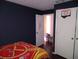 Blue bedroom with closet and open doorway to another room at 10933 Subtle Trail Dr, Riverview, FL 33569