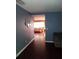 Hallway leading to other living spaces with hardwood floors and attractive wall decor at 10933 Subtle Trail Dr, Riverview, FL 33569