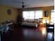 Inviting living room featuring hardwood floors, a ceiling fan, and plenty of natural light at 10933 Subtle Trail Dr, Riverview, FL 33569
