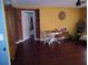 The hardwood floors extend from the living room past a doorway to the adjacent space at 10933 Subtle Trail Dr, Riverview, FL 33569
