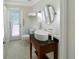 Bright bathroom with modern sink, marble vanity, and walk-out access at 1123 Hounds Run, Safety Harbor, FL 34695