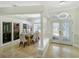 Open-concept dining room boasts abundant natural light, stylish doors, and modern decor at 1123 Hounds Run, Safety Harbor, FL 34695