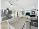 Stylish kitchen boasts stainless steel cabinets, stone countertops, and a seamless transition to the adjacent living area at 1123 Hounds Run, Safety Harbor, FL 34695