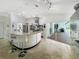 Open kitchen with sleek island, modern appliances, and sliding glass doors leading to an outdoor living space at 1123 Hounds Run, Safety Harbor, FL 34695