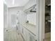 Functional laundry room with stacked washer/dryer and ample storage space at 1123 Hounds Run, Safety Harbor, FL 34695