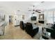 A stylish living room connects to the bar area, highlighted by a fireplace and elegant tile floors at 1123 Hounds Run, Safety Harbor, FL 34695