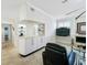 Open floor plan, a fireplace, a wall-mounted television and tile flooring create a welcoming living room space at 1123 Hounds Run, Safety Harbor, FL 34695