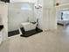 An open main bathroom offers a soaking tub and a walk-in shower, next to a bedroom at 1123 Hounds Run, Safety Harbor, FL 34695