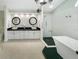 Main bathroom boasts dual sinks, granite counters, a walk-in shower with black stone floor and a soaking tub at 1123 Hounds Run, Safety Harbor, FL 34695