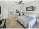 Spacious main bedroom with ensuite bathroom and tile flooring is full of natural light and has a ceiling fan at 1123 Hounds Run, Safety Harbor, FL 34695