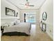 Calm primary bedroom offering a view of the backyard pool and sophisticated design elements at 1123 Hounds Run, Safety Harbor, FL 34695