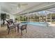 Screened-in lanai featuring a relaxing pool with views of the lake at 1123 Hounds Run, Safety Harbor, FL 34695