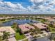 Aerial shot of a beautiful home with a pool and water view in a quiet neighborhood at 16206 Diamond Bay Dr, Wimauma, FL 33598