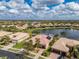 Aerial view of a home featuring a screened-in pool and expansive lake views in a residential neighborhood at 16206 Diamond Bay Dr, Wimauma, FL 33598