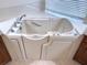 Close up of walk-in bathtub in primary bath at 16206 Diamond Bay Dr, Wimauma, FL 33598