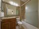 Bathroom featuring granite countertop vanity with sink, toilet, and shower/tub combo with glass door at 16206 Diamond Bay Dr, Wimauma, FL 33598