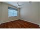Bedroom with hardwood floors, ceiling fan, and window with blinds at 16206 Diamond Bay Dr, Wimauma, FL 33598