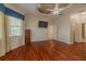 Bright primary bedroom featuring a unique ceiling, ceiling fan, television and walk in closet at 16206 Diamond Bay Dr, Wimauma, FL 33598